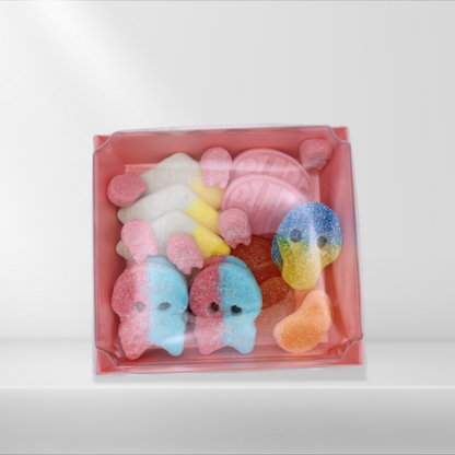 A pink gift box filled with various colorful Swedish gummy candies, including sweet and sour skulls.